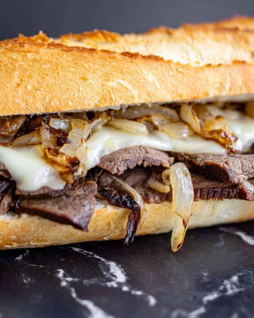 Herb Butter Steak Sandwich with Caramelized Onions and Melted Havarti Recipe