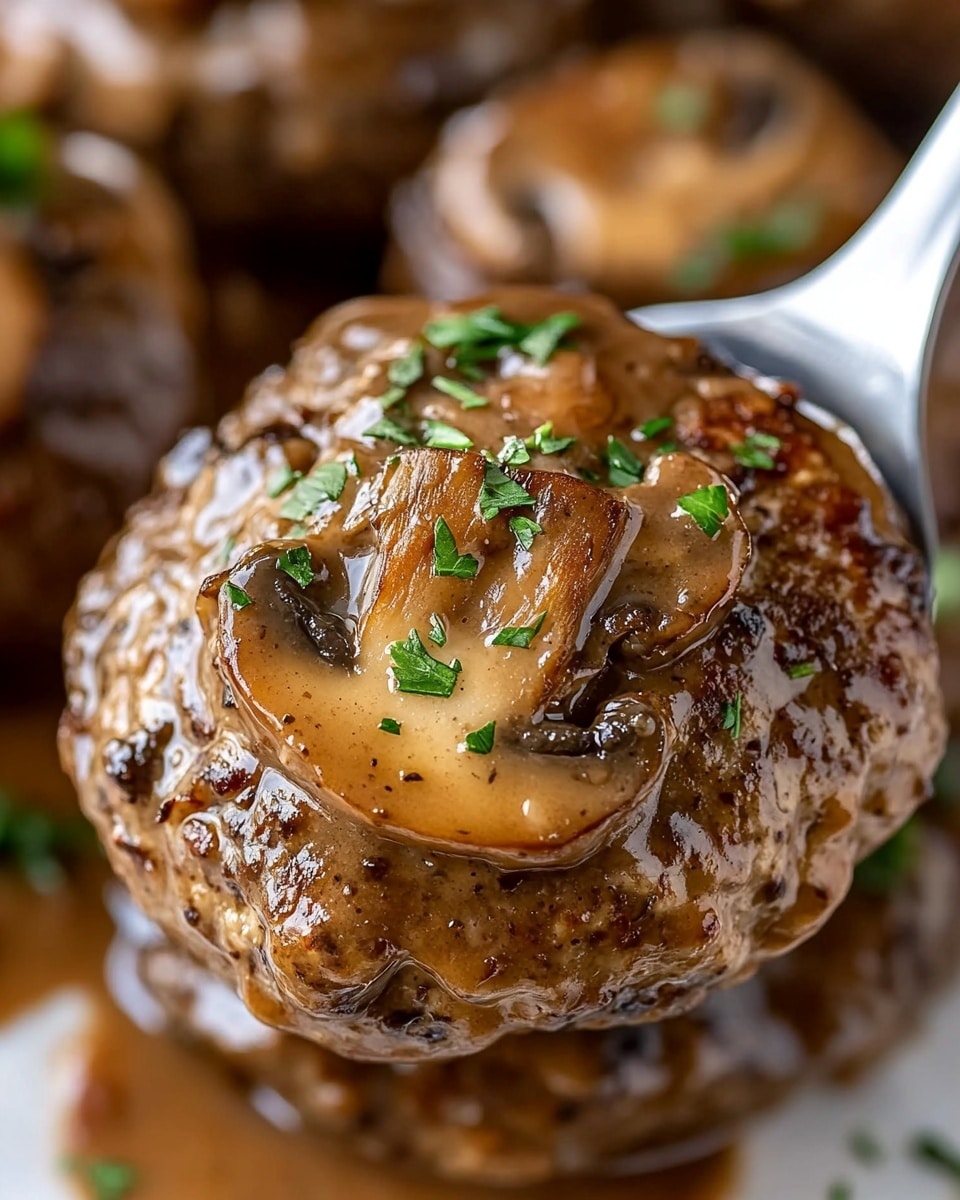 The image shows four browned burger patties covered with a glossy brown mushroom sauce inside a pan. Each patty has two light brown mushroom slices on top, with small green parsley leaves scattered across the patties and sauce. The sauce is smooth and shiny, filling the space around the patties. The pan rests on a white marbled surface, and the focus is close up, showing detailed textures of the meat and sauce. photo taken with an iphone --ar 4:5 --v 6.1