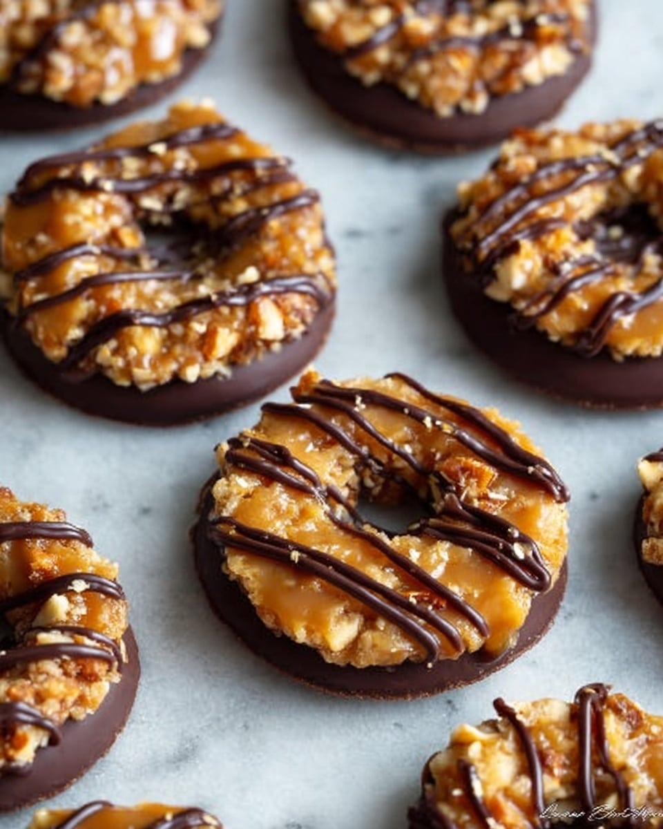 The image shows a tall stack of six round donuts, each donut featuring three clear layers. The bottom layer is dark chocolate, smooth and rich. The middle layer is a light golden dough, soft and fluffy. The top layer is a thick caramel glaze covered with small crunchy nut pieces. Dark chocolate is drizzled artistically over the caramel and nuts on top of each donut. The background is a white marbled texture. Photo taken with an iphone --ar 4:5 --v 7