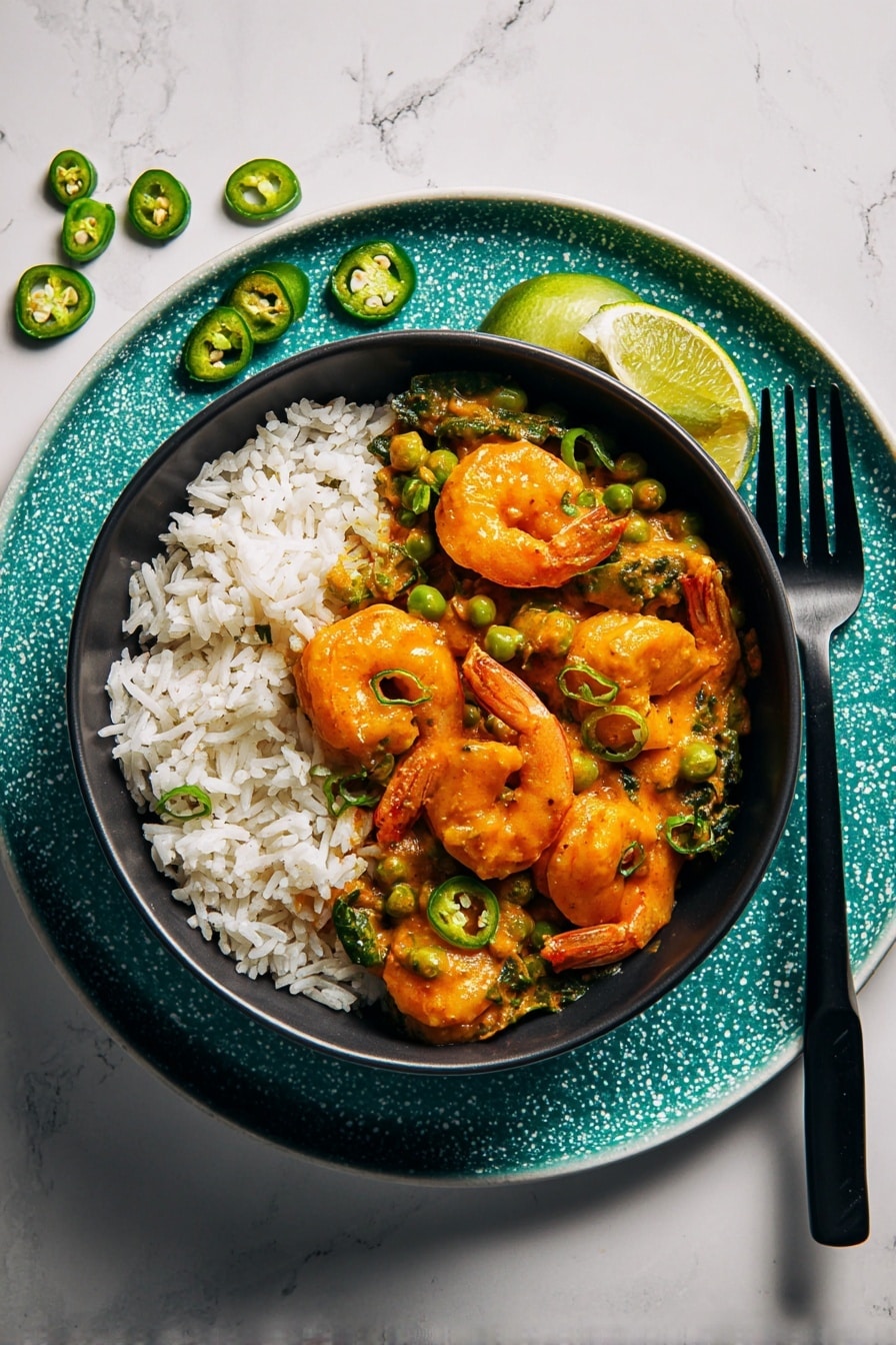 A white bowl filled with white rice forms the bottom layer, topped by a thick orange curry sauce with green peas and spinach leaves mixed in. Large shrimp coated in the sauce are scattered evenly on top, some partially submerged in the curry. Thin slices of green chili peppers are sprinkled over the dish for a touch of freshness and color contrast. The bowl sits on a white plate with a turquoise speckled texture, alongside a black fork and fork prongs pointing up. Next to the fork, there are two lime wedges and some thin slices of green chili placed on the white marbled surface. Photo taken with an iphone --ar 2:3 --v 7 - Coconut Curry Shrimp with Peas, Coconut Curry Shrimp, Easy Shrimp Curry, Healthy Shrimp Recipes, Weeknight Seafood Dinner