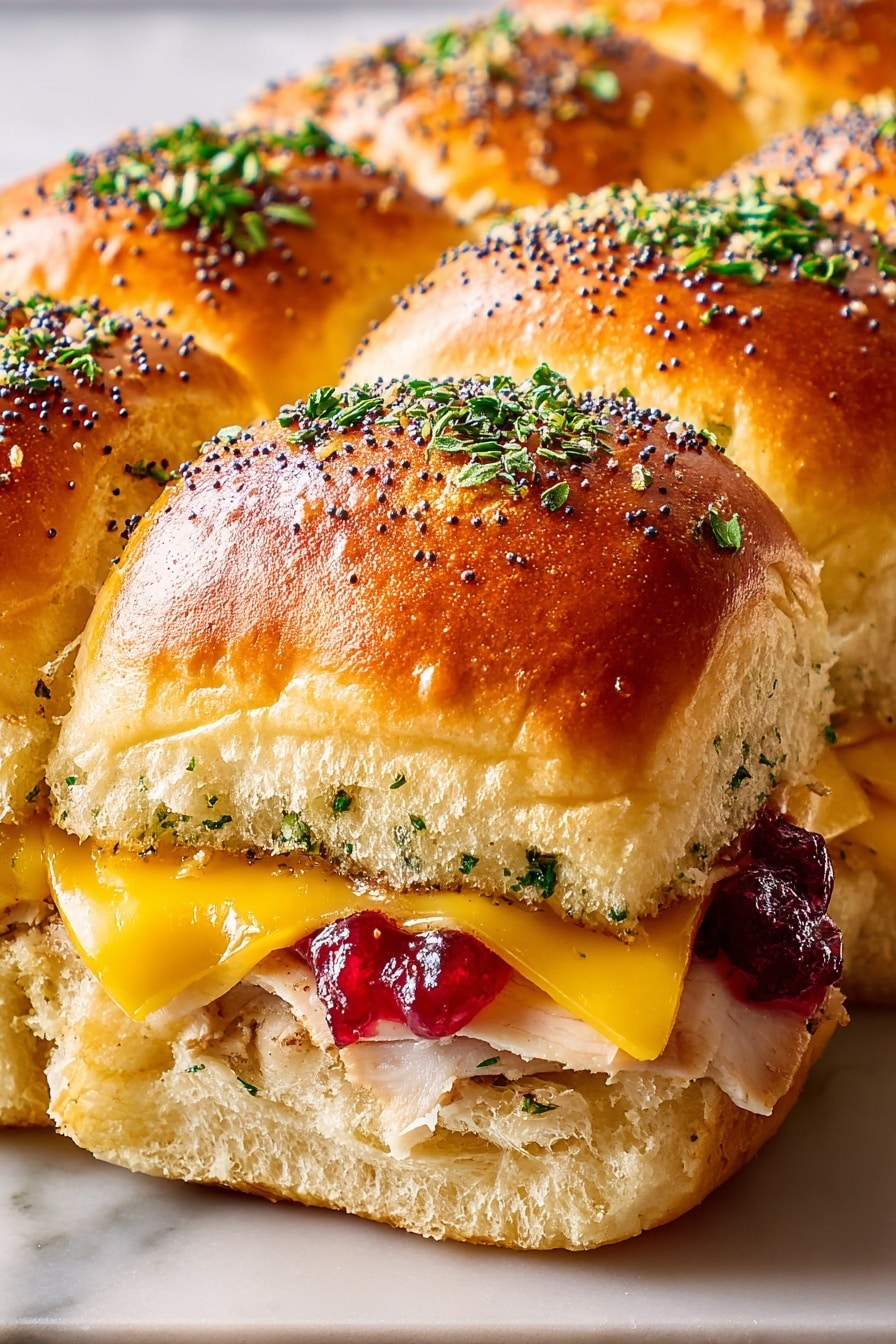 The image shows a close-up of a cluster of golden brown slider buns with a soft, shiny top sprinkled with green chopped herbs and black poppy seeds. Between the top and bottom layers, there is a middle layer with melted bright yellow cheese and cooked light-colored sliced chicken. Some red cranberry sauce peeks out from one side. The sandwich is set on a white marbled surface. Photo taken with an iphone --ar 2:3 --v 7 - Cranberry Turkey Sliders, Thanksgiving sliders, holiday party appetizers, easy turkey sliders, cranberry chicken sliders