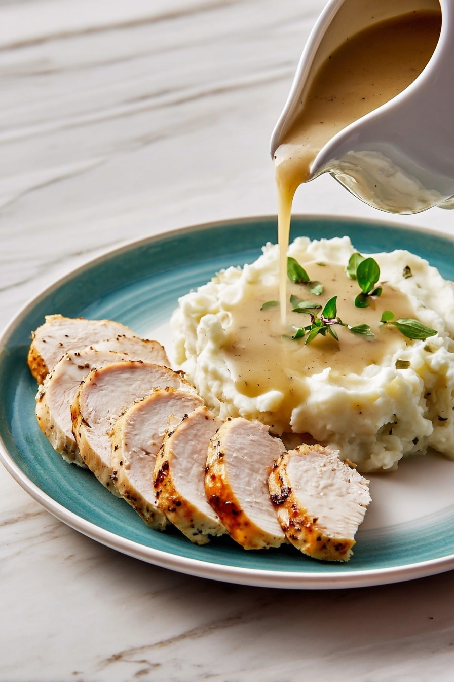 A white plate holds two main layers: on the left side are six slices of cooked chicken with a light brown, slightly peppered surface and white interior, arranged in a neat row. On the right is a mound of creamy white mashed potatoes topped with a few small green herb leaves. Thick brown gravy with bits of onion is being poured over the middle of the mashed potatoes from a white gravy boat above. The background is a white marbled texture. Photo taken with an iphone --ar 2:3 --v 7 - Giblet Gravy, giblet gravy recipe, homemade giblet gravy, turkey gravy with giblets, easy giblet gravy
