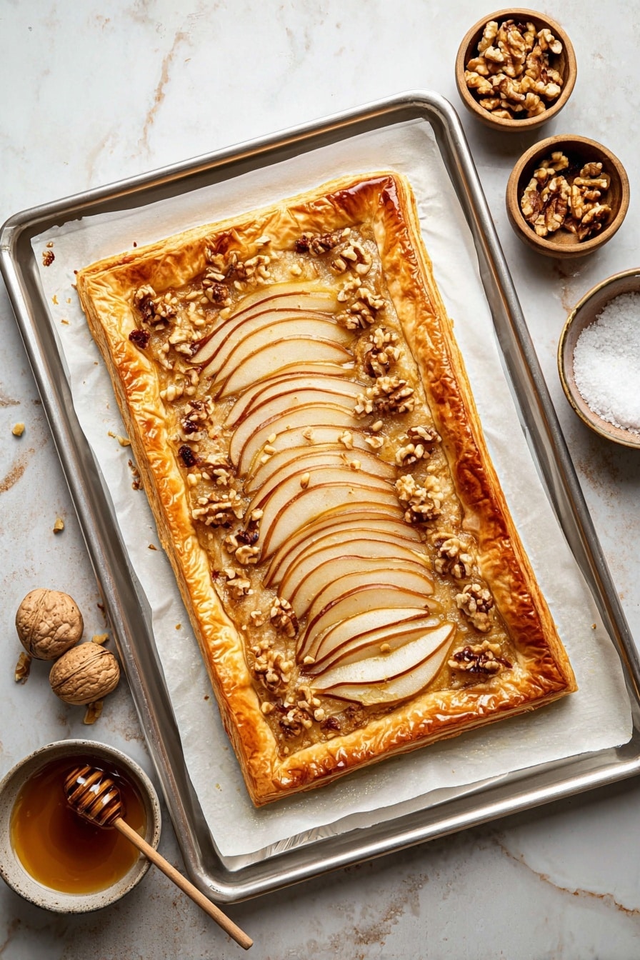 The image shows a square slice of tart with four layers visible. The bottom layer is a golden-brown flaky crust, thick and puffed along the edges. On top of that is a creamy beige layer that looks smooth and soft. The third layer consists of thin slices of pear, light yellow with darker brown edges, arranged like a fan from one corner to another, covering almost the entire slice. The top layer has small light-brown walnut pieces scattered unevenly, with a drizzle of honey or syrup giving a shiny effect over the whole tart. The tart slice is placed on white parchment paper resting on a wooden board, with a white marbled textured surface underneath. Photo taken with an iphone --ar 2:3 --v 7 - Pear, Walnut & Cheddar Puff Pastry Tart, savory pear and cheese tart, quick puff pastry tart recipe, easy cheese and fruit tart, cozy dinner party tart