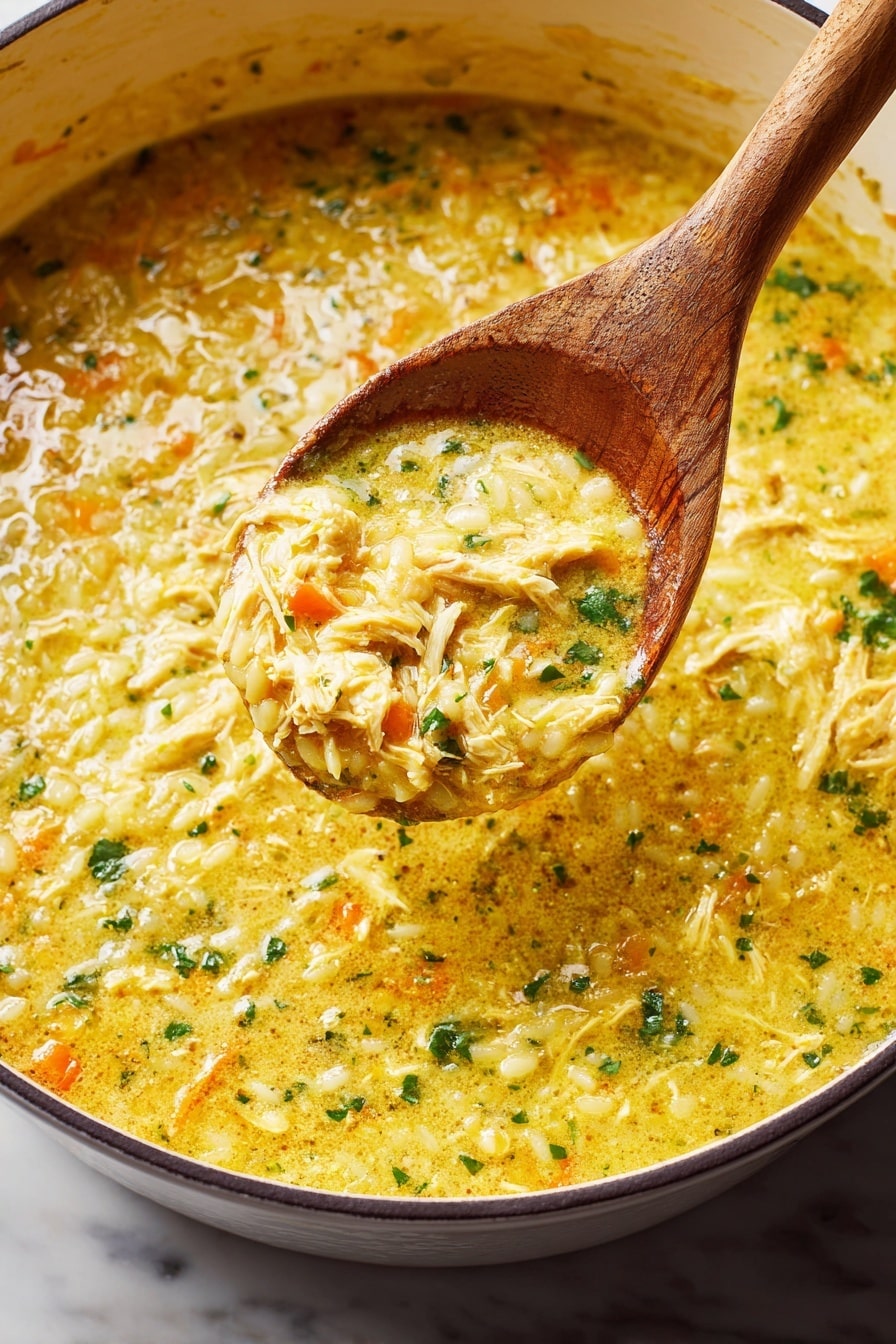 The dish is a thick, creamy soup with a mix of soft yellow and orange colors from the broth and vegetables. It has visible small pieces of green herbs scattered throughout, adding texture and color contrast. A wooden spoon is lifting a scoop of the soup, showing its chunky and slightly lumpy consistency with swirls of light cream and bits of vegetables mixed in. The soup is served in a white pot with a dark rim, sitting on a white marbled surface. photo taken with an iphone --ar 2:3 --v 7 - Italian Penicillin Soup with Egg and Pasta, comforting Italian soup recipes, easy egg and pasta soup, cozy hearty Italian soup, quick weeknight Italian soup