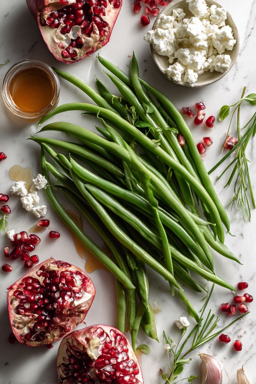 Flat lay of crisp fresh green beans with a vibrant green color, translucent thinly sliced shallots turning golden, jewel-like bright red pomegranate arils scattered lightly, soft crumbled white goat cheese with creamy texture, small sprigs of fresh bright green chopped chives adding contrast, and a small pool of amber maple syrup glistening gently, all naturally arranged with some ingredients overlapping and others spaced evenly, placed on white marbled surface, photo taken with an iphone --ar 2:3 --v 7 - Maple Mustard Green Beans with Pomegranate and Goat Cheese, green bean side dish with pomegranate and goat cheese, healthy green bean recipes, flavorful vegetable sides, easy festive green beans