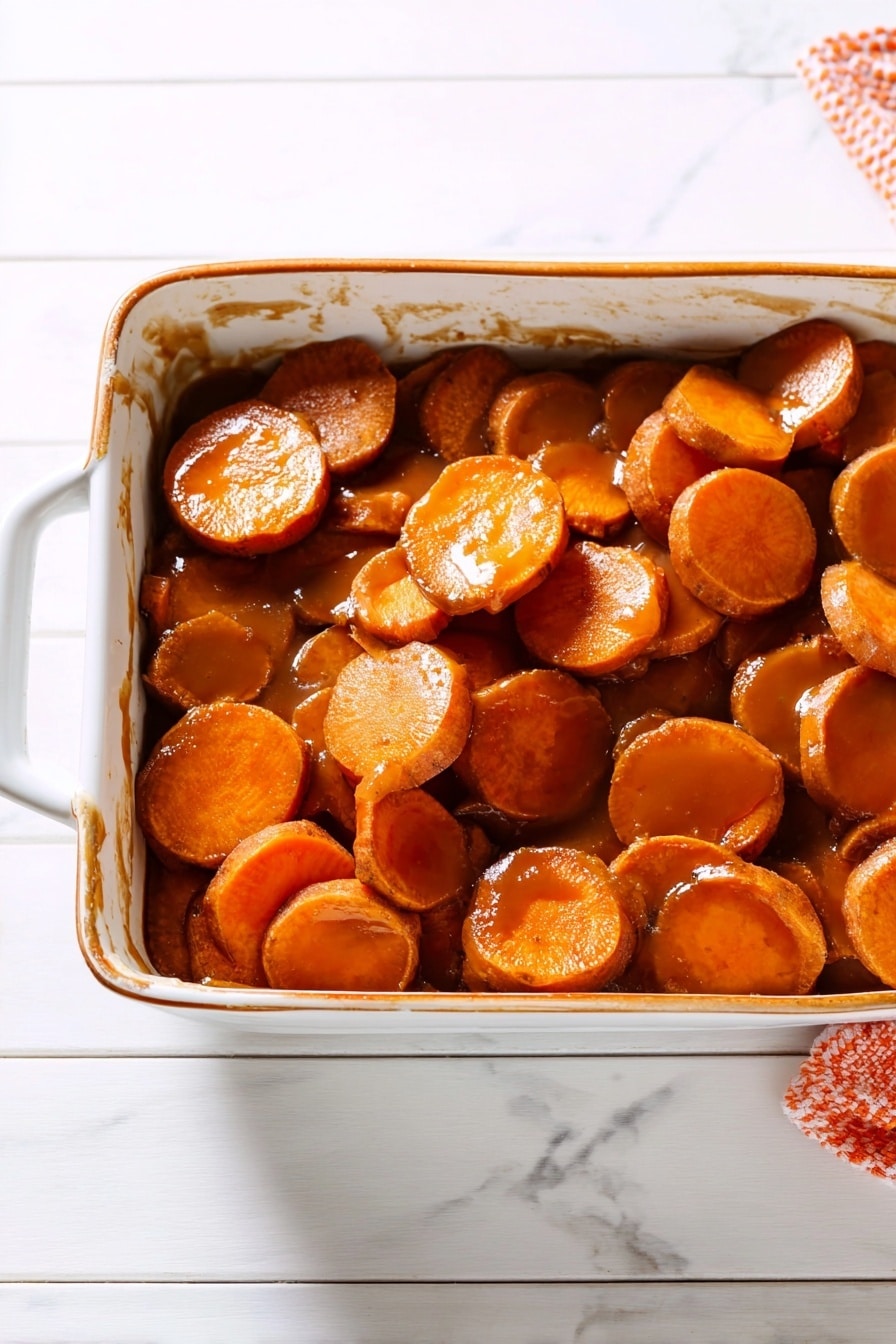 The image shows many thick round slices of cooked carrots, all covered evenly with a shiny brown glaze that makes them look soft and juicy. The slices are stacked close together, filling the whole frame. The colors are mainly bright orange from the carrots mixed with glossy dark brown from the sauce. The background is a white marbled texture. photo taken with an iphone --ar 2:3 --v 7 - Candied Sweet Potatoes, Sweet Potatoes Side Dish, Caramelized Sweet Potatoes, Holiday Sweet Potato Recipe, Cozy Sweet Potato Ideas