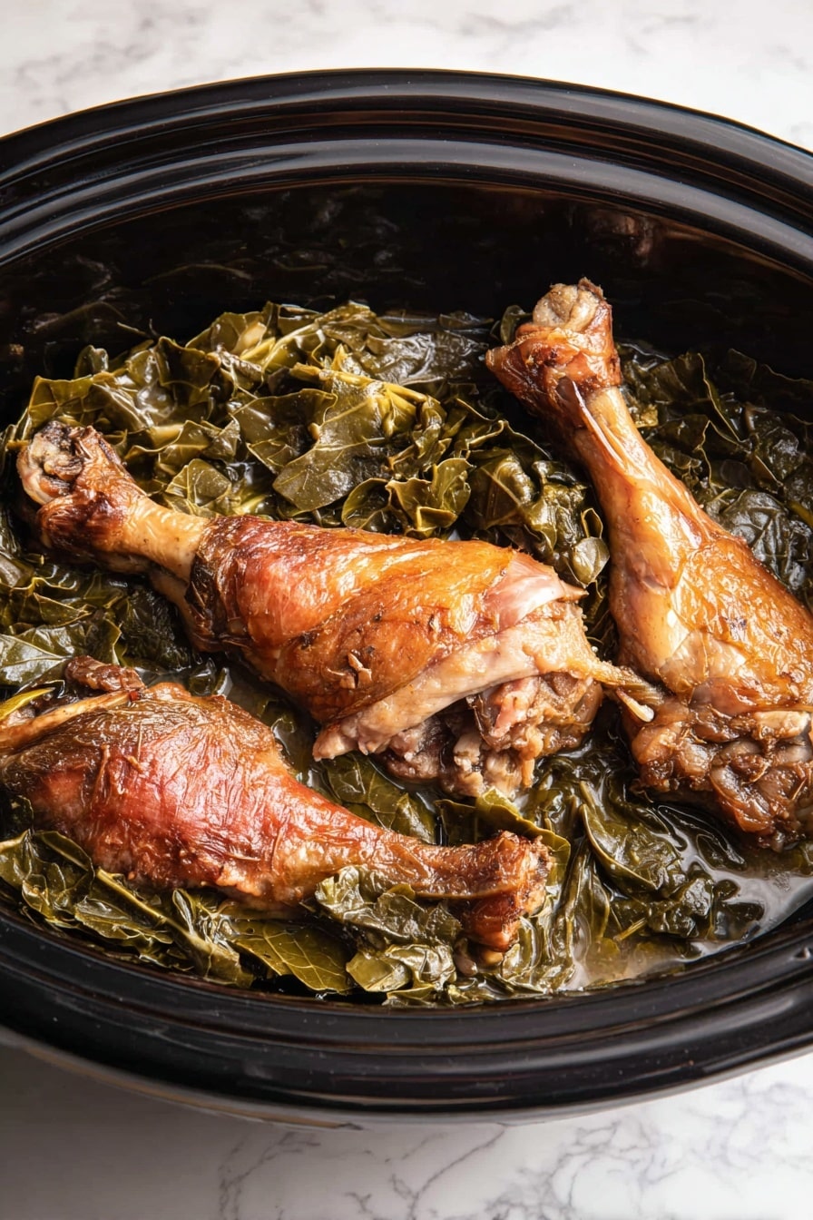 The image shows a black slow cooker filled with cooked greens and three browned turkey legs. The bottom layer consists of dark green cooked leafy greens with a soft, slightly wet texture. On top of the greens, three turkey legs with crispy, browned skin are placed unevenly, showing a rich golden-brown color with some lighter meat spots visible. The slow cooker has a glossy finish, and the whole dish sits on a white marbled surface. photo taken with an iphone --ar 2:3 --v 7 - Slow Cooker Collard Greens with Smoked Turkey, collard greens with smoked turkey, hearty collard greens recipe, slow cooker greens, Southern collard greens cooking