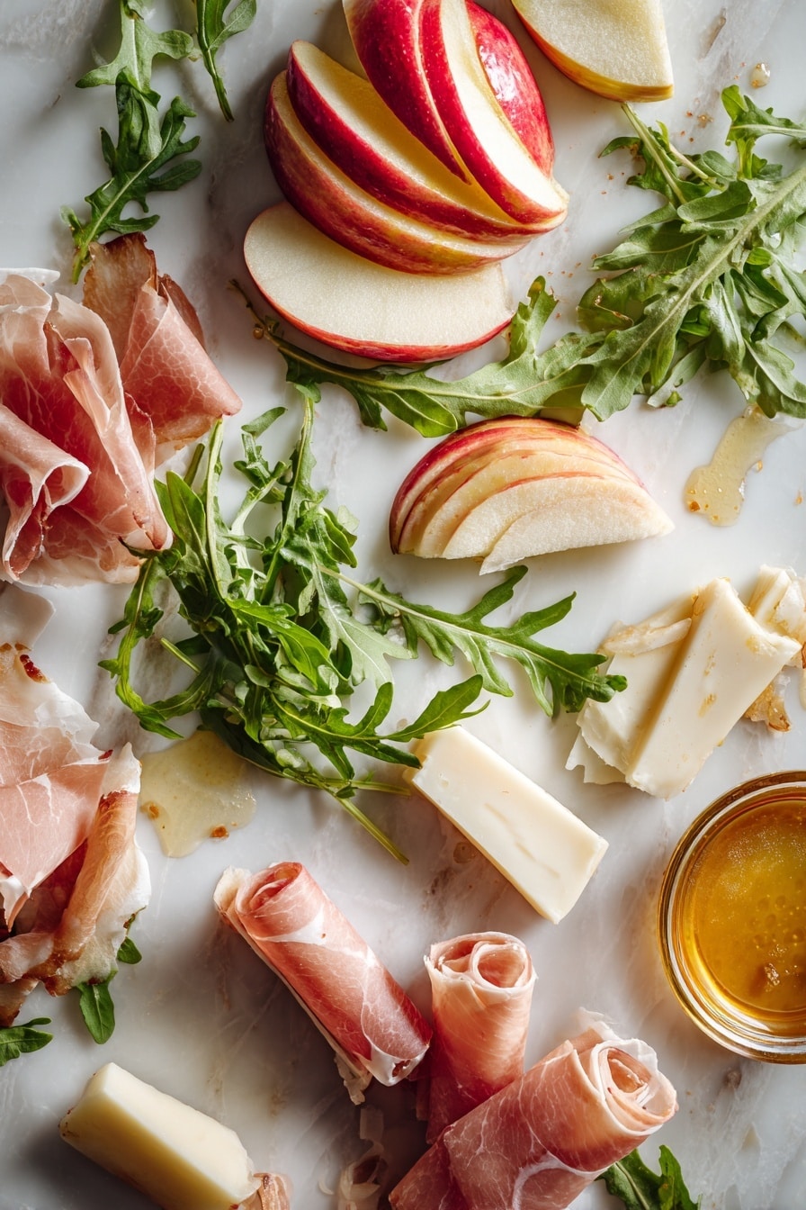 Flat lay of thinly sliced honeycrisp apple with its shiny red and yellow skin, creamy white wedges of brie cheese with smooth rind, delicate pale pink rolled prosciutto pieces, fresh vibrant green arugula leaves with a slightly jagged texture, and fresh golden honey in a small drizzle puddle showing its sticky shine, arranged naturally to highlight their colors and textures, placed on white marbled surface, photo taken with an iphone --ar 2:3 --v 7 - Apple & Brie Crostini with Hot Honey, Apple Brie Crostini appetizer, easy fruit and cheese crostini, hot honey fruit appetizer, elegant snack ideas