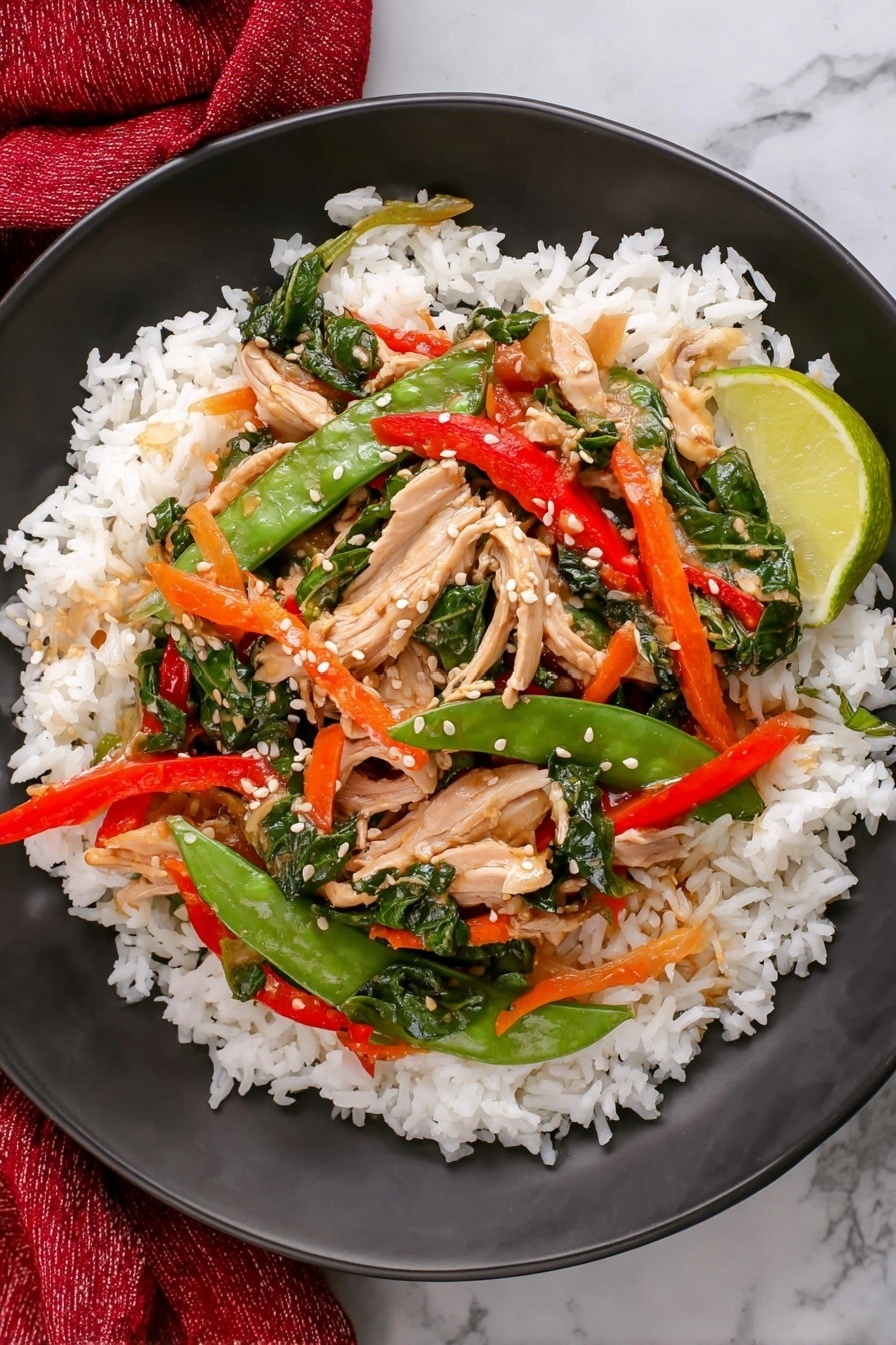The dish is a colorful salad served in a white bowl placed on a white marbled surface. The salad has multiple layers: the bottom layer is a mix of green leafy vegetables and snap peas with a crisp texture; the middle layer contains thin orange carrot strips and red bell pepper slices adding vibrant color; there are scattered pieces of light pink cooked chicken on top. Fresh green basil leaves decorate the edges of the bowl. White sesame seeds are sprinkled over the salad, and two lime wedges rest on one side inside the bowl. Nearby, a smaller white dish with chopped green onions, whole red and green chili peppers, additional basil leaves, and a red cloth are arranged around the bowl. Photo taken with an iphone --ar 2:3 --v 7 - Leftover Turkey Stir Fry with Thai Basil and Veggies, turkey leftover stir fry, easy turkey stir fry recipe, Thai basil stir fry, quick leftover turkey meal