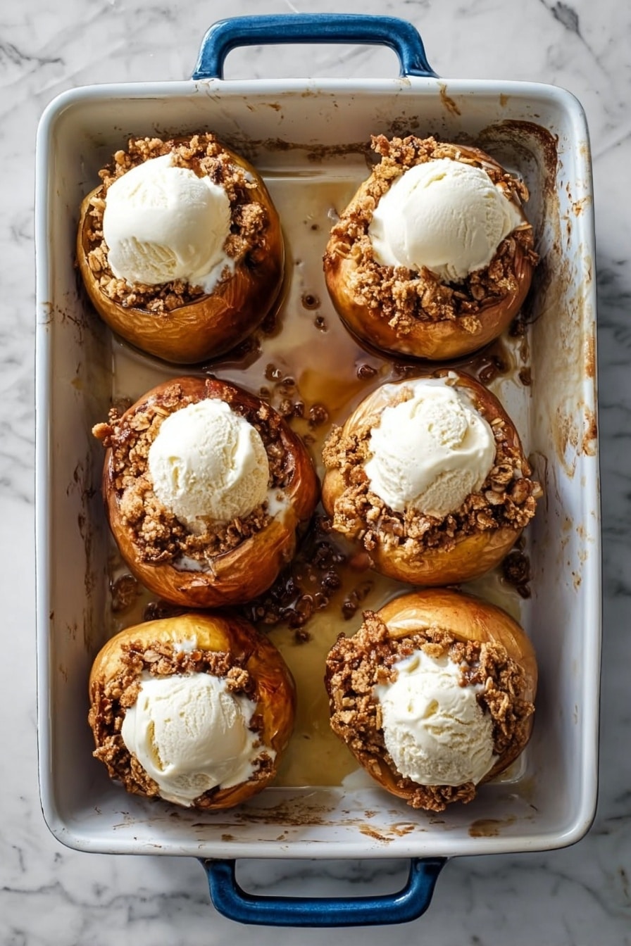 A single baked apple sits on a white plate with syrup pooling around its base, its reddish-brown skin wrinkled and shiny from cooking. The top of the apple is filled with a crumbly, textured mixture of chopped nuts and possibly spices, forming a rough, crunchy-looking layer that contrasts with the smooth, soft apple below. The plate and apple rest on a white marbled surface, with a blurred background showing a glass and a baking dish. Photo taken with an iphone --ar 2:3 --v 7 - Bourbon Baked Apples with Oat-Stuffed Filling and Cinnamon Ice Cream, baked apple dessert, bourbon apple recipe, cozy fall desserts, easy baked apple ideas