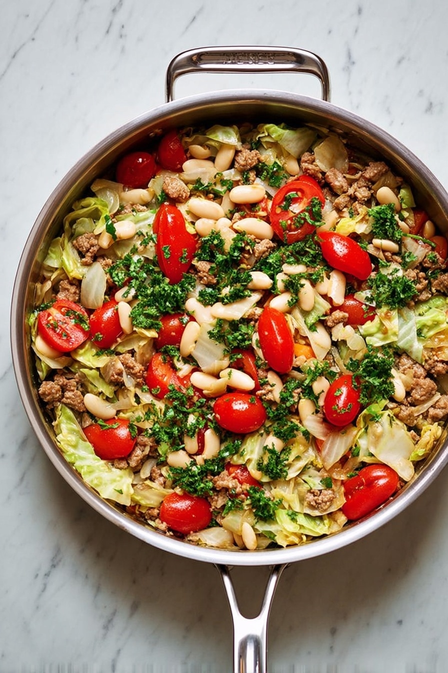 A white bowl filled with a colorful dish that has three main layers: the bottom layer is light green cabbage pieces, the middle layer is a mix of beige white beans and small brown cooked meat chunks, and the top layer has bright red cherry tomatoes and fresh dark green parsley sprinkled all over, with a few slices of light yellow garlic and black pepper visible on top. The bowl sits on a white marbled surface with small white dishes nearby holding chopped parsley and black pepper. Photo taken with an iphone --ar 2:3 --v 7 - Sausage, Cabbage and White Bean Skillet, hearty weeknight dinner, one-pan sausage and cabbage, healthy skillet recipes, easy sausage casserole
