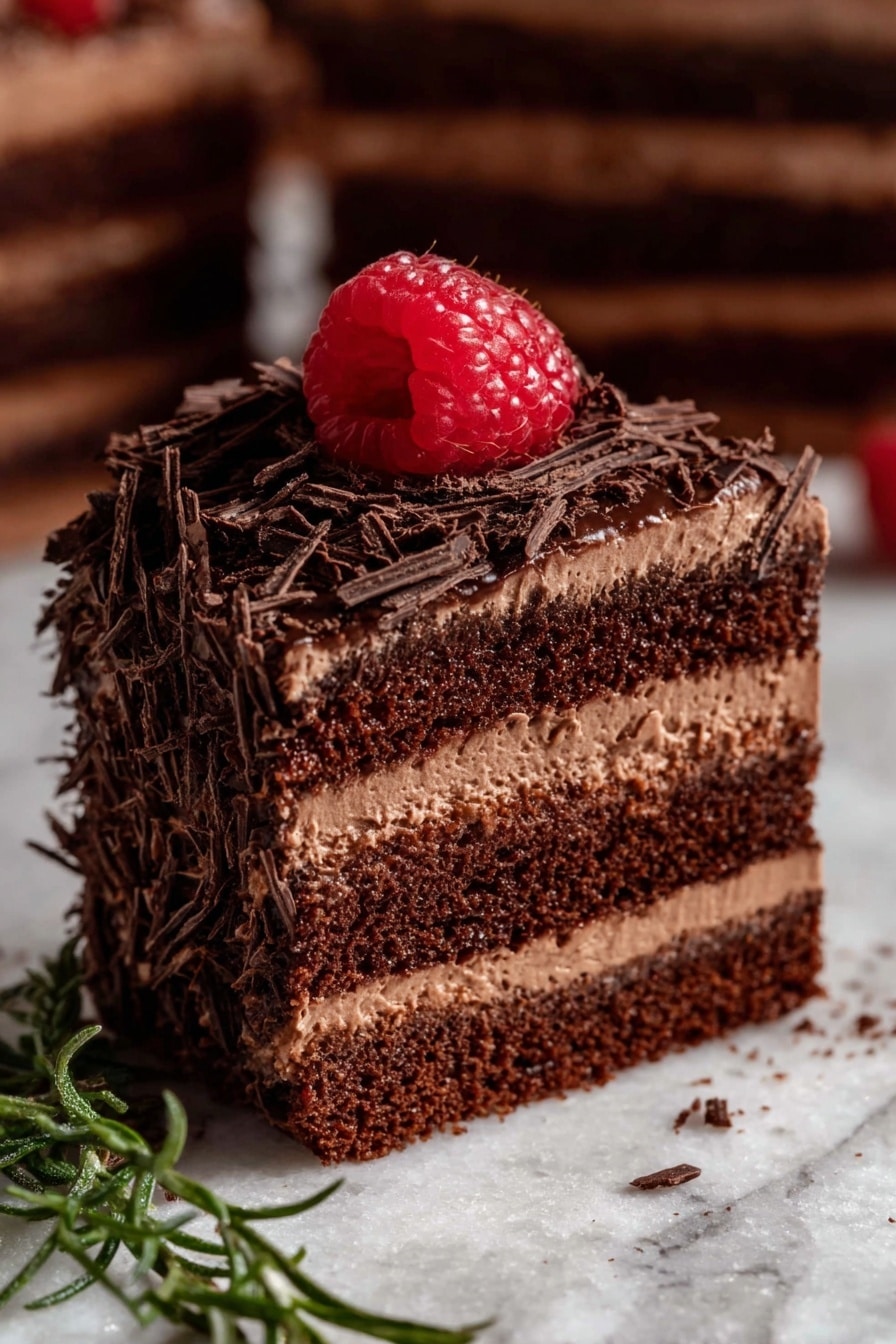This image shows several small round chocolate cakes on a white marbled surface. Each cake has two layers: a smooth dark brown chocolate base and a thick layer of chocolate frosting on top. The frosting is covered with thin, dark chocolate shavings, and each cake is topped with a single bright red raspberry. Around the cakes on the surface are a few extra raspberries and some sprigs of green herbs. There is also a worn golden fork on the left side near one cake. The scene is warm and cozy with soft lighting. photo taken with an iphone --ar 2:3 --v 7 - Mini Chocolate Cake Bites with Fluffy Buttercream, chocolate cake bites, mini chocolate cupcakes, fluffy buttercream frosting, chocolate dessert bites