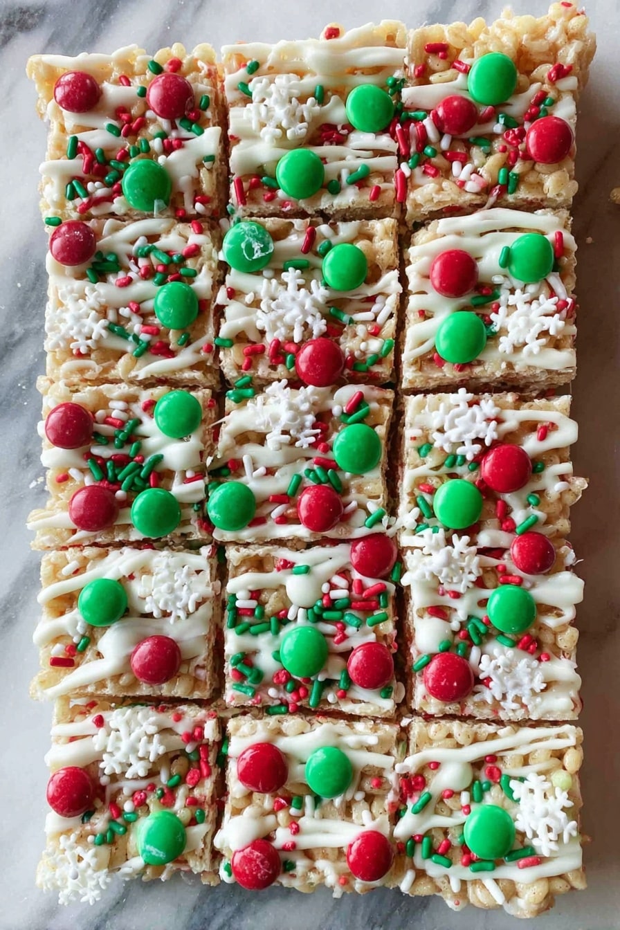 The image shows nine square rice cereal treats arranged in three rows on a white rectangular plate with a decorative edge. Each treat has a light golden color with a slightly sticky and bumpy texture from the cereal. On top of each square, there are red and green candy-coated chocolates and small round sprinkles in red, green, and white, scattered evenly across the surface. The plate sits on a white marbled surface with a blurred green and red holiday-themed background. photo taken with an iphone --ar 2:3 --v 7 - White Christmas Marshmallow Rice Bubble Slice, holiday marshmallow rice bubble treats, festive Christmas snack, easy rice bubble dessert, no-bake holiday treats