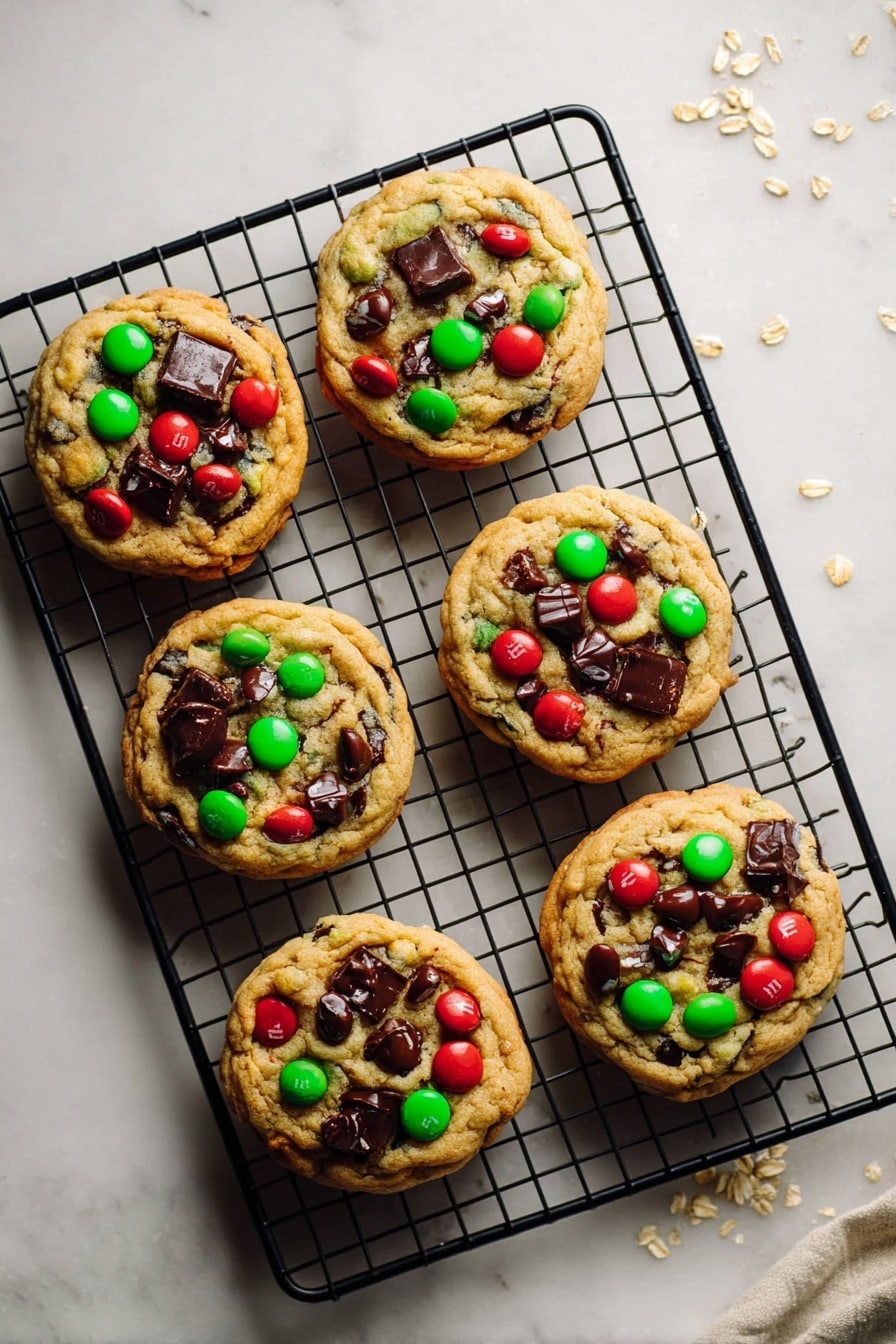Six round cookies with a golden brown base are placed on a black metal cooling rack. Each cookie has large melted dark chocolate chunks and bright red and green candy pieces scattered on top, adding a colorful contrast. The cookies look soft with a slight crackled texture and are evenly spaced on the rack. The rack sits on a white marbled surface with a few scattered oats near the top right corner, giving a fresh baking feel. photo taken with an iphone --ar 2:3 --v 7 - Christmas M&M Cookies, festive cookie recipes, holiday treat ideas, colorful Christmas cookies, easy Christmas cookie recipes