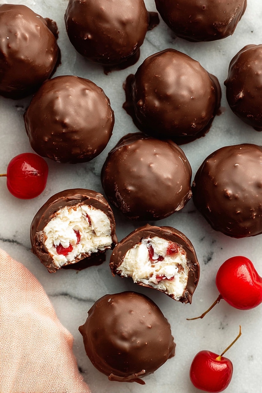 A white, wavy-edged dish holds a stack of round chocolate balls with a dark, smooth outer layer. One chocolate ball is opened on top, showing an inner layer of white, shredded coconut mixed with small bright red cherry pieces. The dish also contains bright red cherries placed near the chocolate balls. The background is a white marbled surface with scattered coconut shreds and some brown nut pieces. A soft pink cloth is placed next to the dish. Photo taken with an iphone --ar 2:3 --v 7 - Martha Washington Cherry Balls, holiday cherry candies, nostalgic holiday treats, festive coconut pecan candies, cherry truffles with chocolate coating
