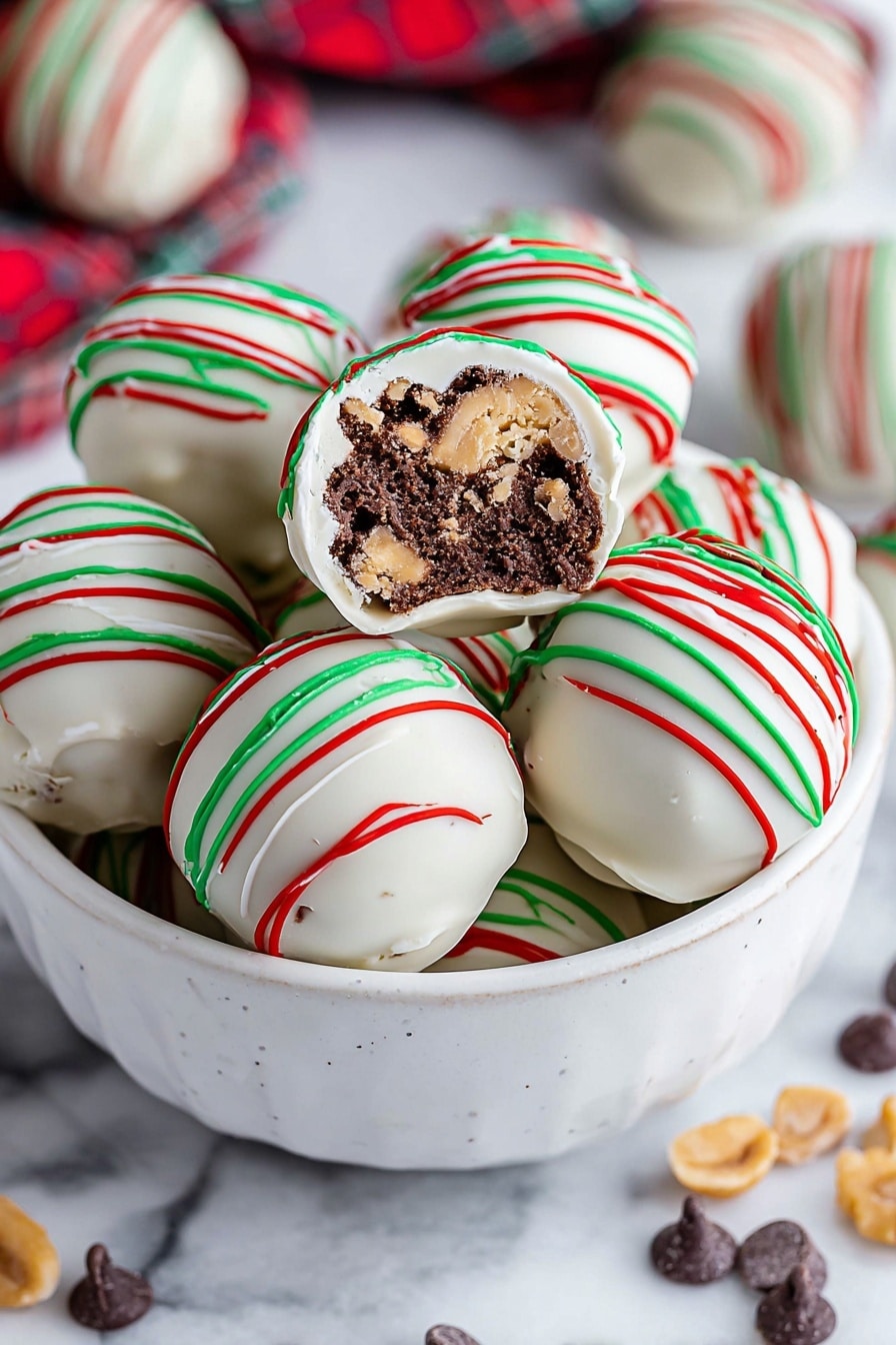 Round white chocolate balls sit on brown parchment paper on a white marbled surface. Each ball is covered smoothly in white chocolate and topped with thin red and green chocolate drizzles crossing over the top and sides. Around the balls, there are scattered dark chocolate chips and small pieces of chopped nuts. The white chocolate balls are arranged casually, with some blurred in the background, giving a close-up focus on the front ball. Photo taken with an iphone --ar 2:3 --v 7 - Chocolate Almond Truffles, chocolate almond candies, easy homemade truffles, decadent chocolate treats, almond chocolate confections