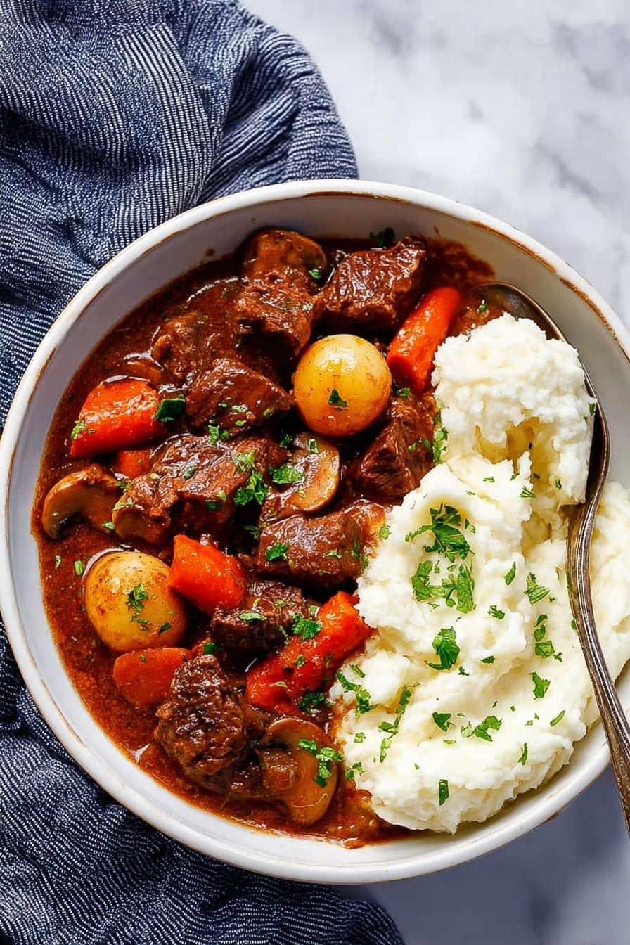 The image shows a close-up of a dark bowl filled with rich beef stew. The dish has large chunks of dark brown beef, bright orange carrot pieces, and small golden baby potatoes, all covered in a thick brown sauce. Fresh green parsley is sprinkled on top, adding a pop of color. In the background, there is a small portion of white mashed potatoes. The bowl sits on a white marbled surface with soft natural light highlighting the textures. photo taken with an iphone --ar 2:3 --v 7 - Slow Cooker Beef Bourguignon, beef bourguignon, hearty beef stew, easy slow cooker dinner, French beef stew