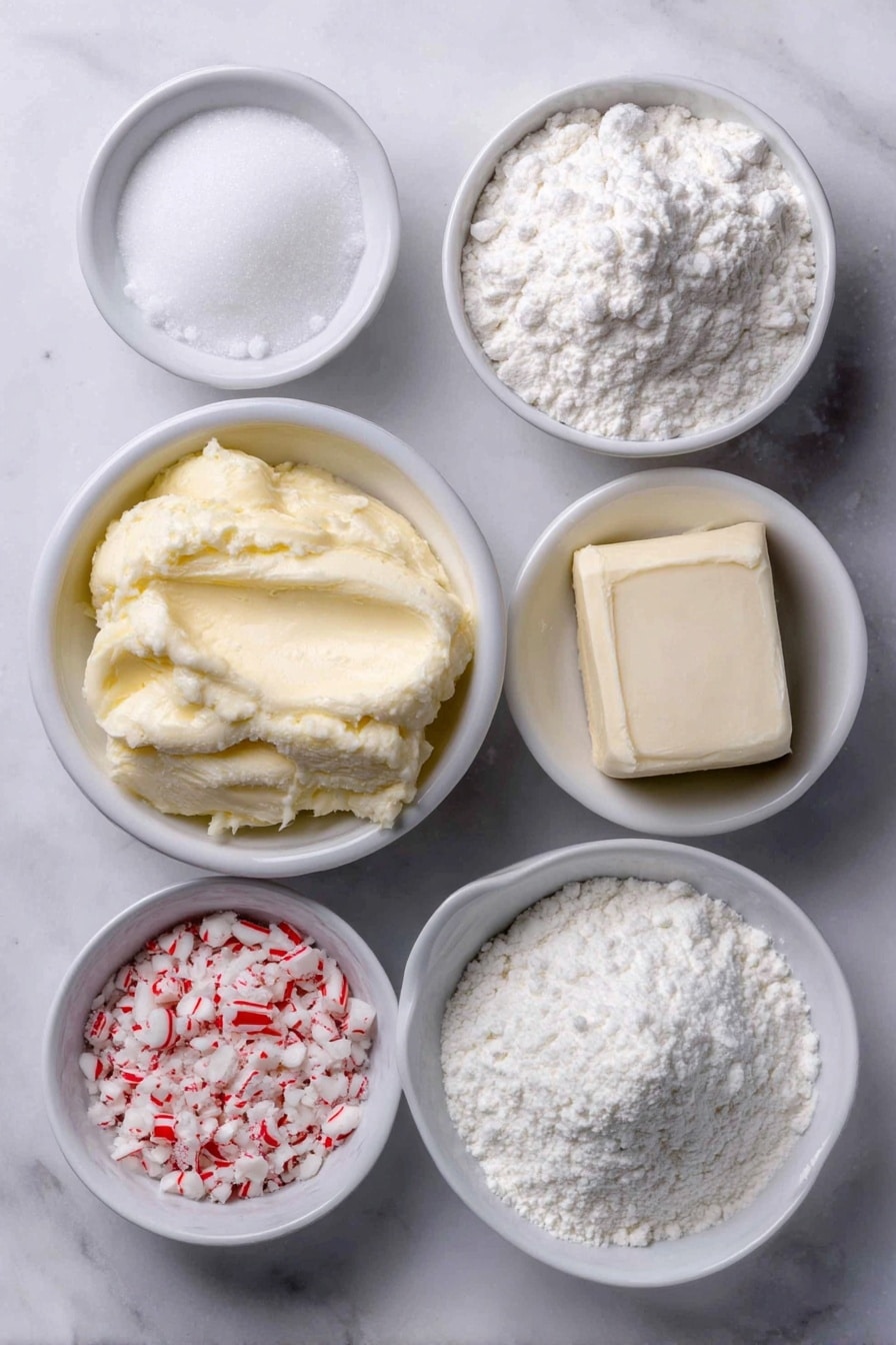 Flat lay of a small white ceramic bowl of softened unsalted butter, a small white ceramic bowl filled with powdered sugar, a small white ceramic bowl containing all-purpose flour, a small white ceramic bowl with cornstarch, a small white ceramic bowl holding crushed candy canes, a small white ceramic bowl of cream cheese block, a small white ceramic bowl of softened salted butter, a few whole uncracked brown eggs (representing freshness although not used in this recipe), and a small white ceramic bowl of clear peppermint extract liquid, all arranged symmetrically and balanced, with fresh natural textures and colors, placed on a clean white marble surface, soft natural light, photo taken with an iPhone, professional food photography style, fresh ingredients, white ceramic bowls, no bottles, no duplicates, no utensils, no packaging --ar 2:3 --v 7 --p m7354615311229779997 - Peppermint Meltaways Cookies, holiday peppermint cookies, buttery peppermint cookies, peppermint dessert recipes, Christmas cookies