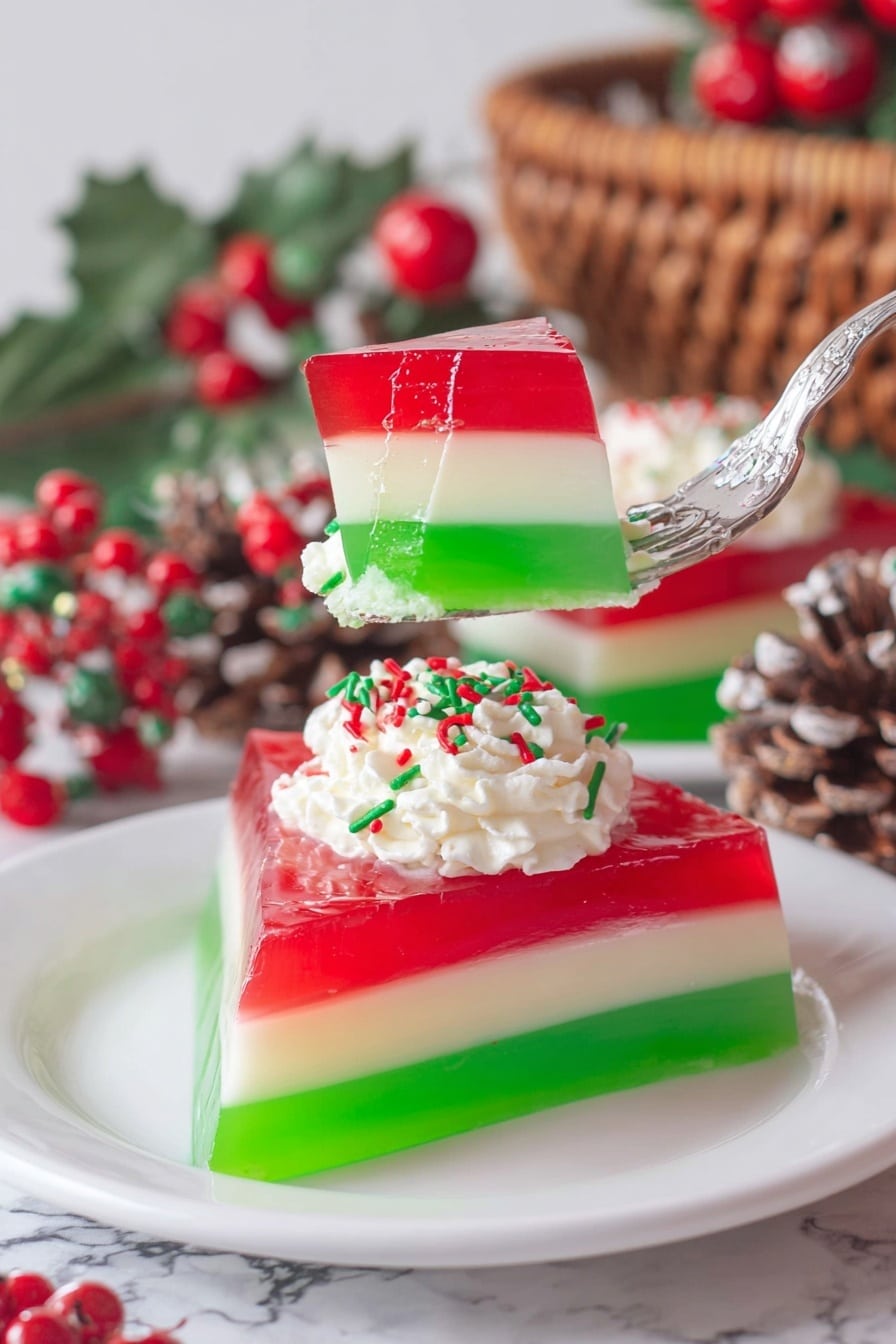 The image shows three square-shaped layered gelatin desserts on white round plates placed on a white marbled surface. Each dessert has three visible layers with the bottom layer in green, a thin white middle layer, and a thick bright red top layer that looks smooth and shiny. On top of each dessert, there is a small dollop of white whipped cream decorated with red, green, and white sprinkles. To the right side, near the bottom corner, there is a small wooden bowl filled with the same colored sprinkles. The setting is bright and clean, showcasing the colorful treats clearly photo taken with an iphone --ar 2:3 --v 7 - Christmas Ribbon Salad, festive layered Jell-O salad, holiday side dish, colorful party salad, Christmas dessert salad