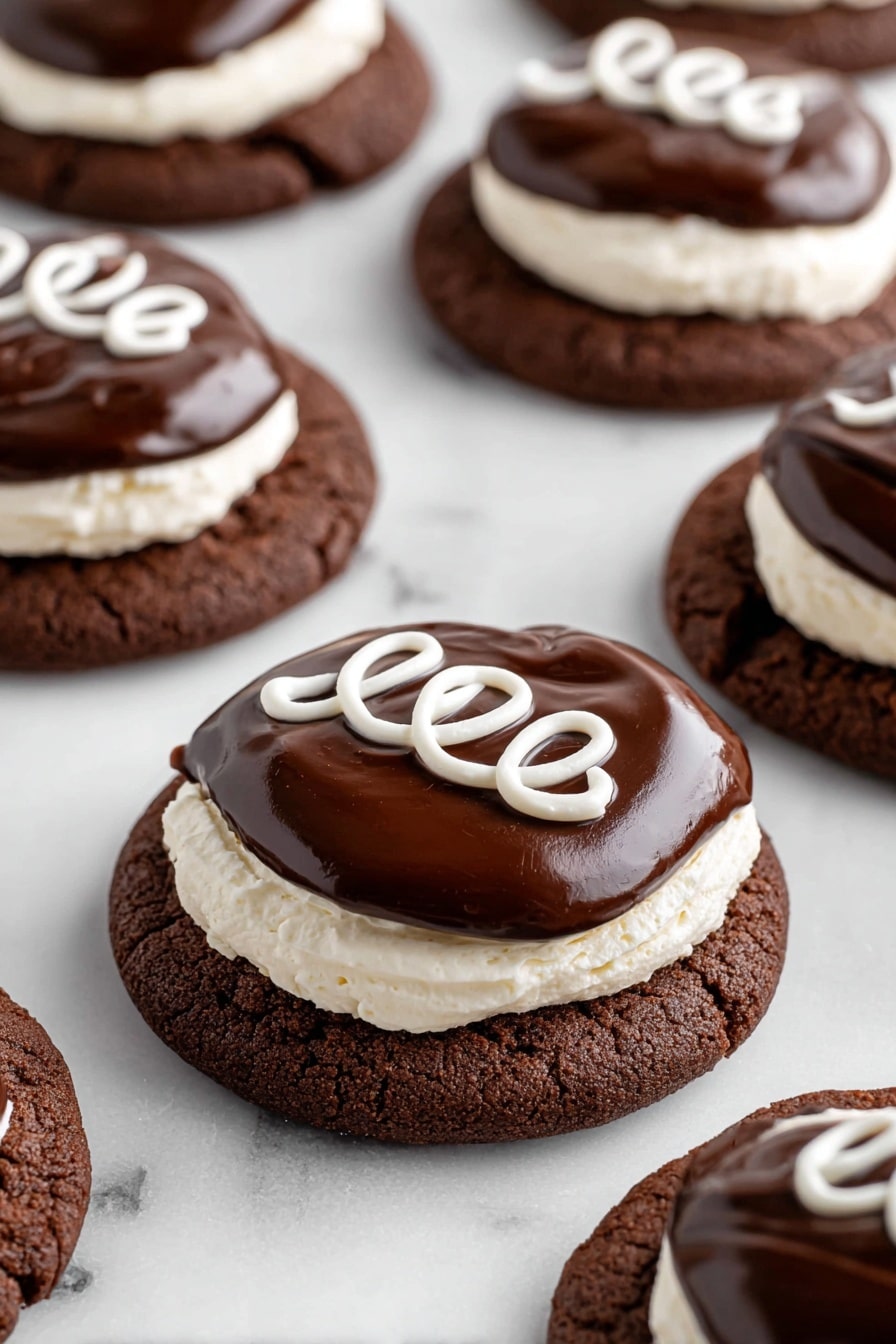The image shows a stack of two chocolate cookies with a soft, cracked texture and dark brown color. Each cookie is topped with a thick layer of white creamy frosting, smooth and fluffy, followed by a glossy dark chocolate ganache layer on top. The top cookie in the stack has a bite taken out, revealing the creamy white frosting and the moist, dark brown inside of the cookie. A small swirl of white frosting is piped on top of the ganache. The cookies sit on a white marbled surface with other similar cookies blurred in the background. photo taken with an iphone --ar 2:3 --v 7 - Hostess Cupcake Cookies with Marshmallow Frosting, nostalgic cookie recipes, chocolate marshmallow cookies, homemade Hostess cupcake treats, marshmallow frosting cookies