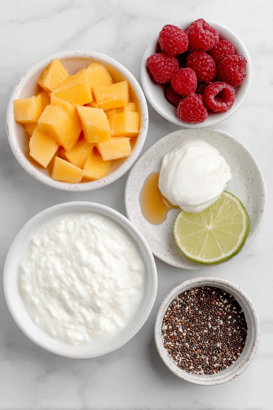 Flat lay of fresh ripe mango chunks, fresh raspberries, a small white ceramic bowl of creamy non-dairy yogurt, a small white ceramic bowl filled with almond milk, a halved lime showing juicy pulp, a small white ceramic bowl with black chia seeds, a neat scoop of protein powder on a white ceramic plate, and a small white ceramic bowl of golden honey placed on a clean white marble surface, soft natural light, photo taken with an iPhone, professional food photography style, fresh ingredients, white ceramic bowls, no bottles, no duplicates, no utensils, no packaging --ar 2:3 --v 7 --p m7354615311229779997 - Mango Raspberry Smoothie with Chia Seeds, healthy mango raspberry smoothie, easy fruit smoothie recipes, nutritious chia seed smoothies, vibrant berry mango drink